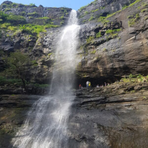 Anjani Kund Waterfall cascading down rocky cliffs surrounded by lush greenery in Dang district, Gujarat